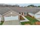 Charming townhome featuring an attached garage, landscaped front yard, and inviting front entryway at 653 Huntingdon St, Elon, NC 27244