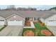 Inviting single-story home featuring an attached garage, manicured lawn, and a welcoming front entrance at 653 Huntingdon St, Elon, NC 27244
