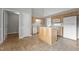Well-lit kitchen featuring wood cabinets, a functional island, and white appliances, offering ample counter space at 653 Huntingdon St, Elon, NC 27244