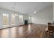 Bright living room with hardwood floors, french doors, and fireplace at 653 Huntingdon St, Elon, NC 27244