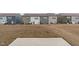 A large backyard featuring a concrete patio and expansive views of neighboring homes at 656 Dallas Rose Dr, Wendell, NC 27591