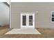 Backyard features a concrete patio with double doors and a grassy area at 656 Dallas Rose Dr, Wendell, NC 27591