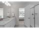 Stylish bathroom with granite countertops, double sinks, a walk-in shower, and a convenient view to the connected bedroom at 656 Dallas Rose Dr, Wendell, NC 27591