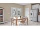 Cozy dining area with a wooden table, a refrigerator, and convenient access to the backyard at 656 Dallas Rose Dr, Wendell, NC 27591