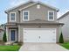 Charming two-story home with a gray exterior, white trim, and an attached two-car garage at 656 Dallas Rose Dr, Wendell, NC 27591