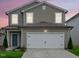 Charming two-story home with a gray exterior, white trim, and an attached two-car garage at 656 Dallas Rose Dr, Wendell, NC 27591