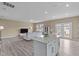 Open concept kitchen with island seating that flows into the living room, great for entertaining at 656 Dallas Rose Dr, Wendell, NC 27591