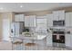 Modern kitchen with stainless steel appliances, granite countertops, and a center island with seating at 656 Dallas Rose Dr, Wendell, NC 27591