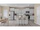 Well-lit kitchen featuring white cabinetry, an island, and modern appliances for a clean and functional space at 656 Dallas Rose Dr, Wendell, NC 27591