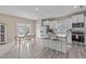 Bright, airy kitchen featuring white cabinetry, stainless steel appliances, and a center island at 656 Dallas Rose Dr, Wendell, NC 27591