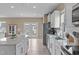 Spacious kitchen with a center island, stainless steel refrigerator, and access to the backyard at 656 Dallas Rose Dr, Wendell, NC 27591