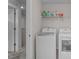 Laundry room features modern washer and dryer units, storage shelves, and easy access at 656 Dallas Rose Dr, Wendell, NC 27591