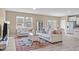 Open-concept living room featuring neutral tones, stylish furniture, and abundant natural light at 656 Dallas Rose Dr, Wendell, NC 27591