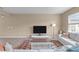 Inviting living room with modern decor, a large TV, and light-colored wood flooring at 656 Dallas Rose Dr, Wendell, NC 27591