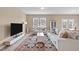 Bright living room with a large rug, comfortable seating, and a modern entertainment center at 656 Dallas Rose Dr, Wendell, NC 27591