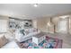 Open-concept living room with a view of the kitchen, stylish furniture, and hardwood floors at 656 Dallas Rose Dr, Wendell, NC 27591