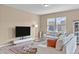 Bright living room featuring a large TV, comfortable seating, and contemporary decor at 656 Dallas Rose Dr, Wendell, NC 27591