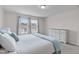 Inviting main bedroom bathed in natural light, complemented by a cozy bed, soft linens, and ample space for relaxation and rest at 656 Dallas Rose Dr, Wendell, NC 27591