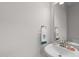 Powder room features a decorative mirror, white sink, bronze faucet and white walls at 656 Dallas Rose Dr, Wendell, NC 27591
