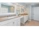 Beautiful primary bath featuring double sinks, granite countertops, and a large mirror above each sink at 7533 Silver View Ln, Raleigh, NC 27613