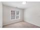 Bright bedroom with neutral paint, carpet flooring, and a window bringing in ample natural light at 7533 Silver View Ln, Raleigh, NC 27613