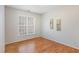 Cozy bedroom with hardwood floors, a large window, and neutral paint, creating a relaxing atmosphere at 7533 Silver View Ln, Raleigh, NC 27613