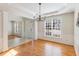 Bright dining room with hardwood floors, large window, elegant lighting, and decorative molding at 7533 Silver View Ln, Raleigh, NC 27613