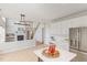 Modern kitchen featuring white cabinets and stainless steel appliances, with an open view into living room at 7533 Silver View Ln, Raleigh, NC 27613