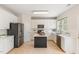Well-lit kitchen with white cabinets, stainless steel appliances, tile backsplash, and center island at 7533 Silver View Ln, Raleigh, NC 27613