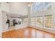 Spacious living room with a vaulted ceiling, large windows, hardwood floors and open concept design at 7533 Silver View Ln, Raleigh, NC 27613