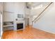 Bright living room featuring fireplace, hardwood floors, and elegant staircase at 7533 Silver View Ln, Raleigh, NC 27613