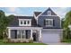 Charming two-story home with gray siding, stone accents, covered front porch and attached two car garage at 7553 Percussion Dr, Apex, NC 27539