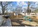 Wooden back deck featuring a grill, seating, and view of the fenced backyard with storage sheds at 805 N Elizabeth St St, Durham, NC 27701