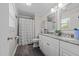 Bathroom featuring dual sinks with granite counters and a shower with patterned curtain at 805 N Elizabeth St St, Durham, NC 27701