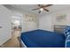 Comfortable bedroom featuring a blue bed, ceiling fan, closet and hardwood floors at 805 N Elizabeth St St, Durham, NC 27701