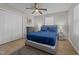 Cozy bedroom with a plush blue bed, ceiling fan, and a closet for organized storage at 805 N Elizabeth St St, Durham, NC 27701