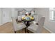 Dining area adjacent to the living room with a black table and seating for four guests at 805 N Elizabeth St St, Durham, NC 27701