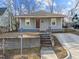 Charming single-story home with gray siding, concrete walkway, and inviting brown front door at 805 N Elizabeth St St, Durham, NC 27701