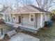 Inviting one-story home showcasing a cozy front porch with decorative iron supports at 805 N Elizabeth St St, Durham, NC 27701