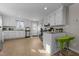 Open concept kitchen with white cabinets, breakfast bar, and stainless steel appliances at 805 N Elizabeth St St, Durham, NC 27701