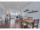 An open-concept dining area shows a wood table, shelving, and a modern kitchen with stainless steel appliances at 829 Winter Meadow Dr, Wake Forest, NC 27587