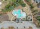 Aerial view of community clubhouse with pool, parking, and a playground at 8304 Rosiere Dr, Cary, NC 27518
