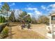 A serene backyard with lush landscaping provides a brick patio, a built-in fire pit, and privacy fencing at 8304 Rosiere Dr, Cary, NC 27518
