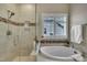 This primary bathroom features a soaking tub and a separate glass-enclosed shower at 8304 Rosiere Dr, Cary, NC 27518