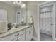 A stylish bathroom features a large mirror, granite countertops, and a shower stall at 8304 Rosiere Dr, Cary, NC 27518