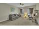 A cozy room offers a comfortable couch, workspace desk, and lots of natural light from the two large windows at 8304 Rosiere Dr, Cary, NC 27518
