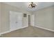 This bedroom features carpet, double closet doors, and a modern ceiling fan at 8304 Rosiere Dr, Cary, NC 27518