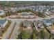 Aerial view of a two-story home with a community pool surrounded by residential houses at 8304 Rosiere Dr, Cary, NC 27518