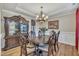 Elegant dining room with wood floors, tray ceiling, and a decorative chandelier at 8304 Rosiere Dr, Cary, NC 27518