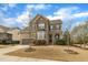 Charming two-story brick home with a well-manicured lawn and inviting curb appeal at 8304 Rosiere Dr, Cary, NC 27518